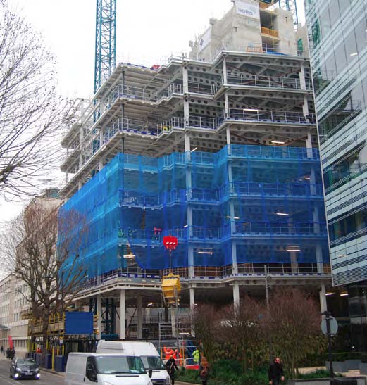 The building occupies a plot adjacent to an underground station
