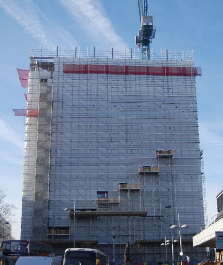 Sheeting encloses the tower as the new floors are erected