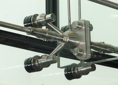 Stainless steel attachment to glazed facade and glass fin for stability