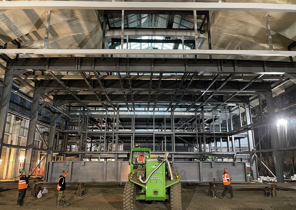 One of the roof girders is manoeuvred into place