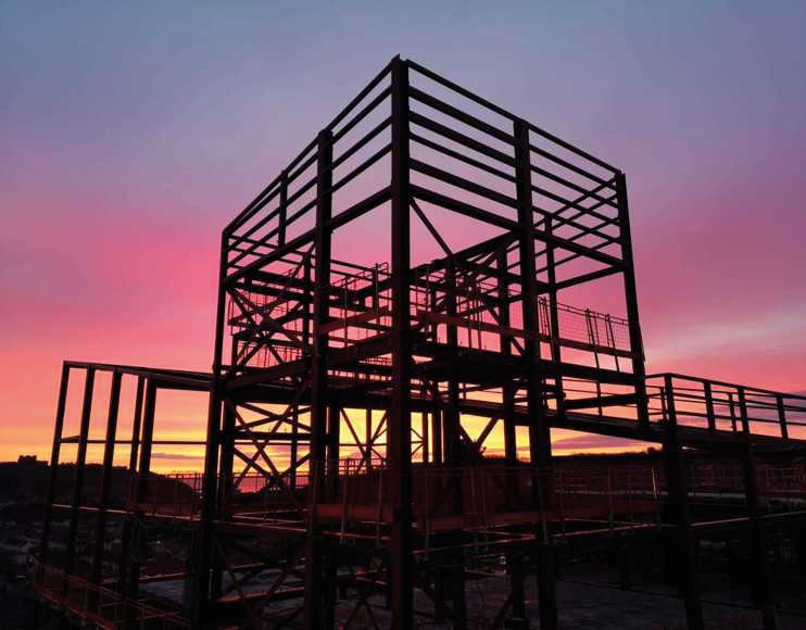 The steel frame includes a distinctive tower that will be topped with a flagpole