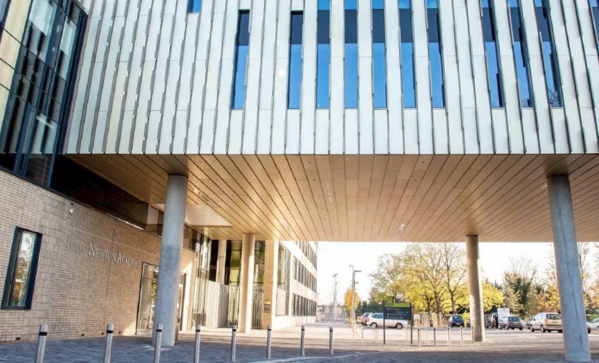 The sports beam projects over a public car park