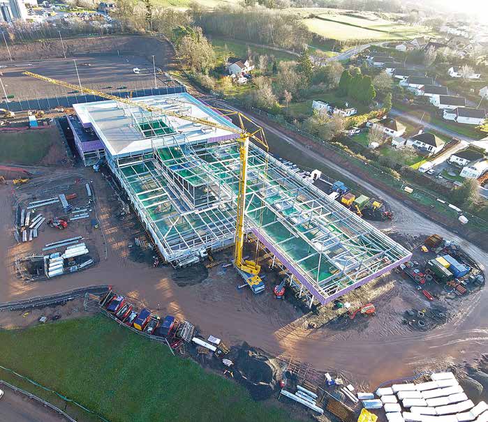 The campus juts out from the slope with the sports pitches located behind on a plateau