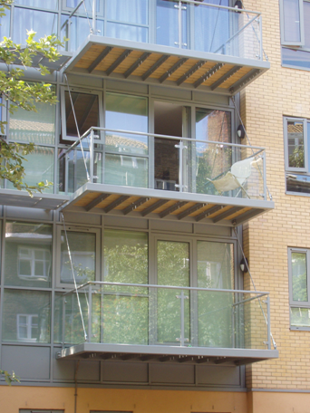 Steel balcony system tied to the supporting structure at floor levels
